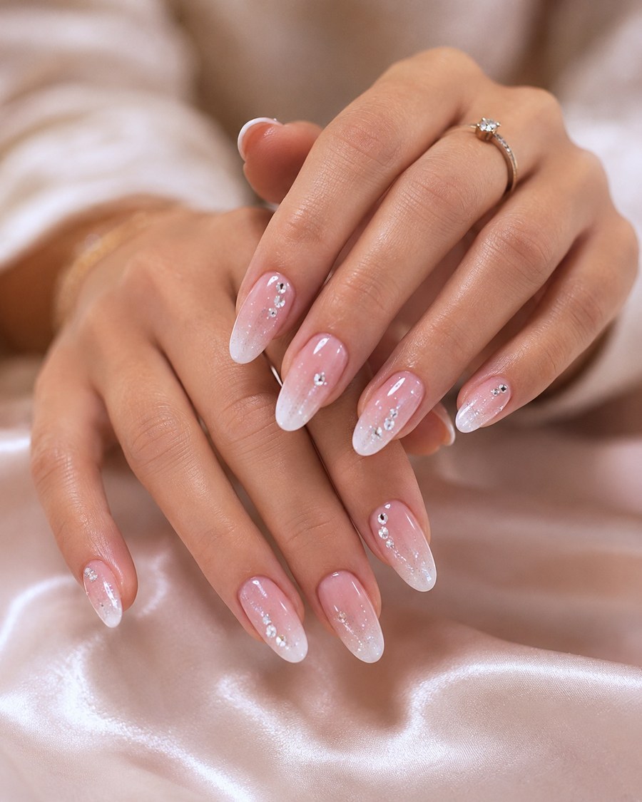Pink ombré nails with crystal accents, both hands